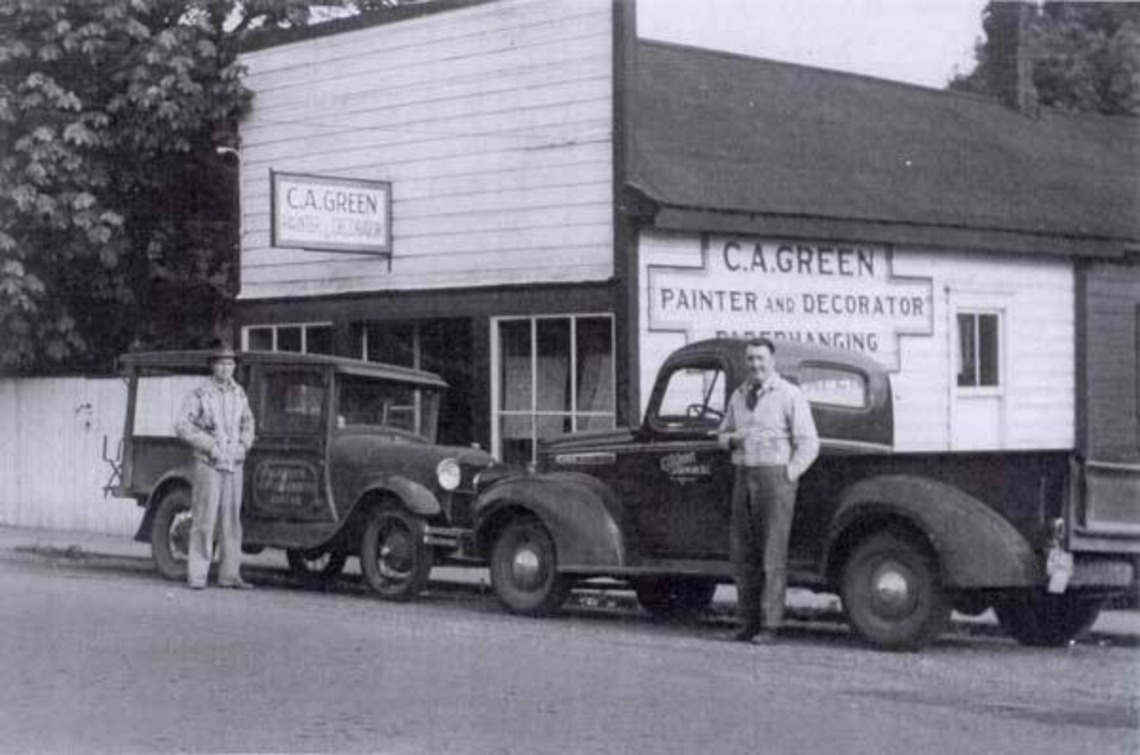 Claude Green (right) in front of his business building at 161 Kenneth Street, circa 1940. The sign on the exterior wall behind Claude Green is still visible on 161 Kenneth Street today