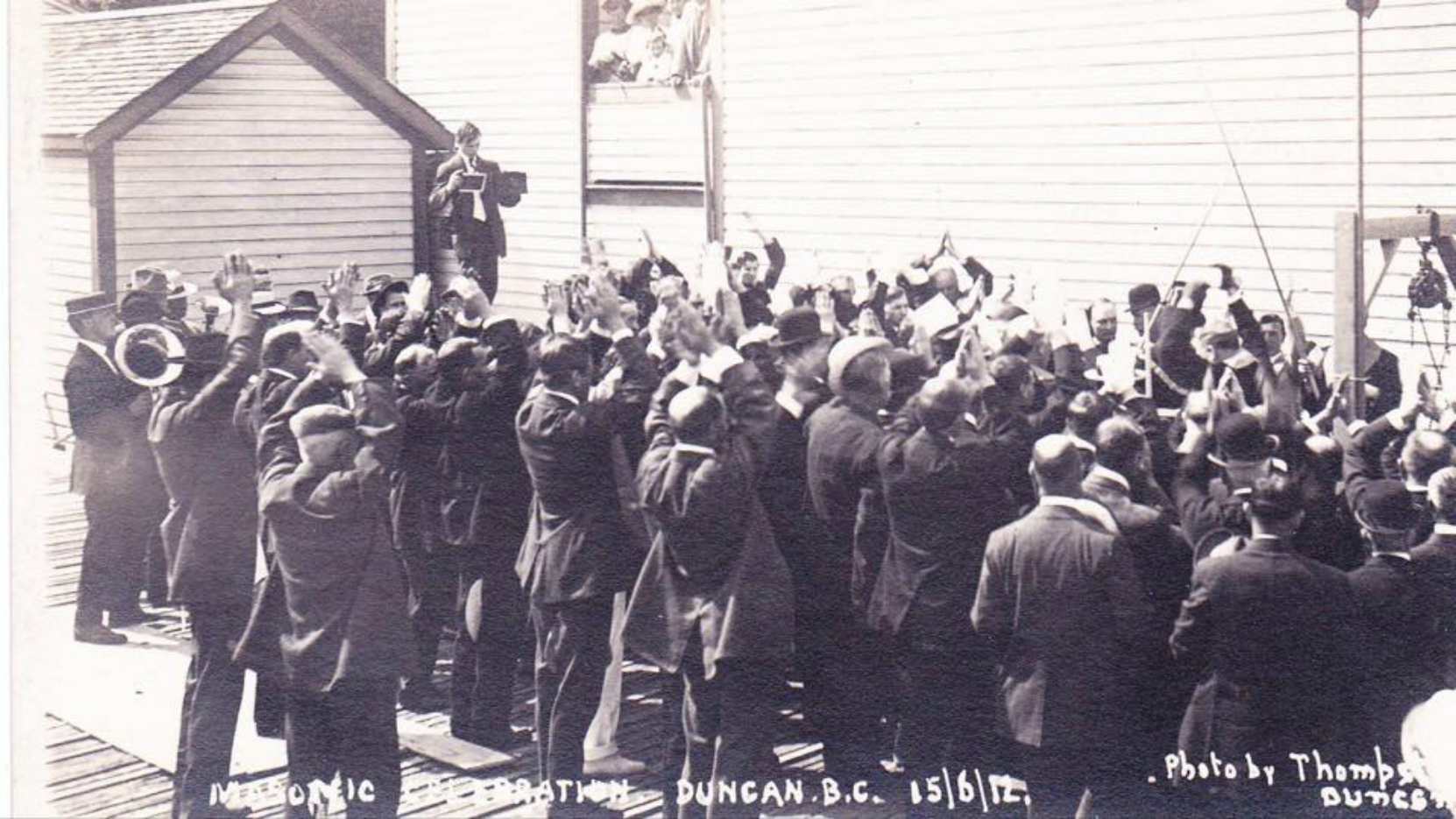 Corner Stone Ceremony for the present day Duncan Masonic Temple, 15 June 1912. Mrs. Norcross' chicken coop is visible in the left rear.